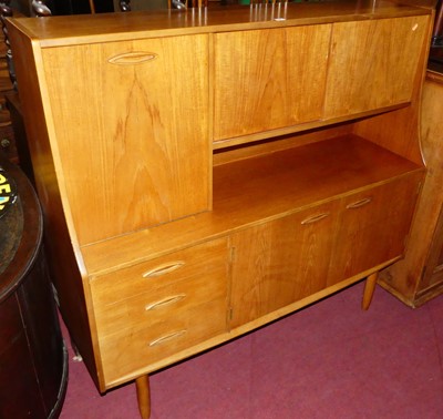 Lot 1248 - A 1960s teak side cabinet, having fall front...