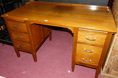 Lot 1261 - A 1930s walnut ledgeback kneehole writing desk,...
