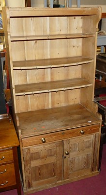 Lot 1264 - A joined pine dresser, the three open upper...
