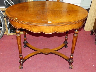 Lot 1270 - A 1920s figured walnut and crossbanded oval...