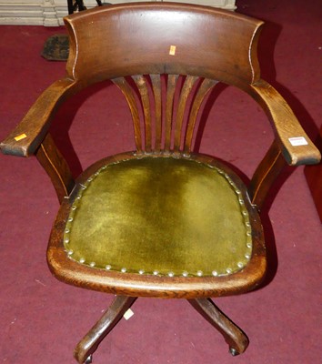 Lot 1301 - A 1930s oak slatback swivel tub desk chair,...
