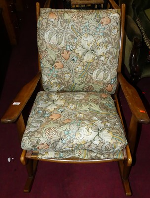 Lot 1305 - A 1960s beech rocking elbow chair, with floral...