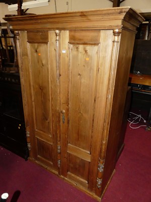 Lot 1322 - A pine double door armoire, raised on squat...