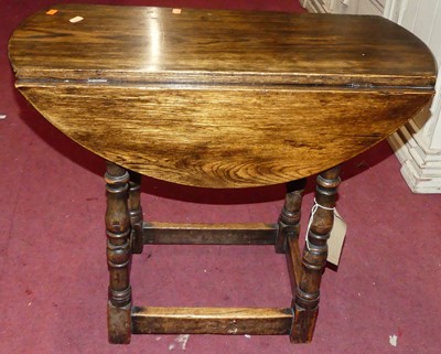 Lot 1342 - A joined oak dropflap low occasional table,...