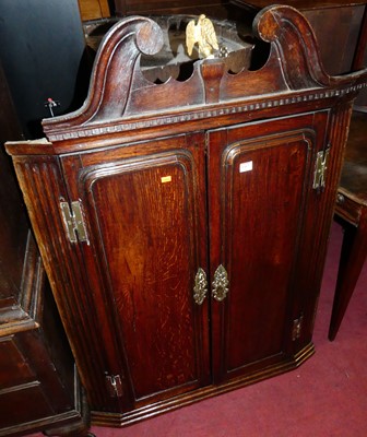 Lot 1367 - A George III oak double door hanging corner...