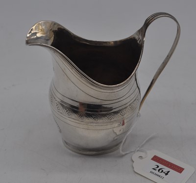 Lot 264 - A George III silver helmet shaped cream jug...