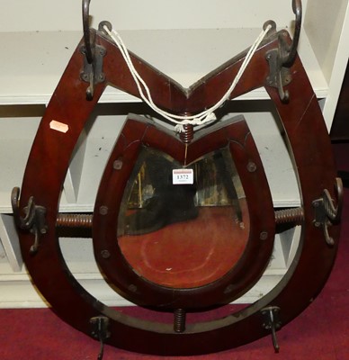 Lot 1372 - An Edwardian walnut horseshoe mirror, w.52cm