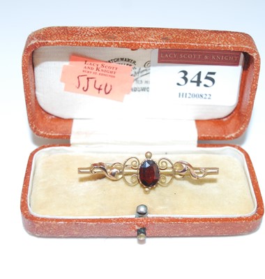 Lot 345 - A circa 1900 9ct gold and garnet set bar...
