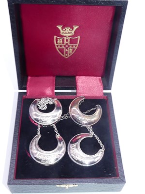 Lot 317 - A set of four modern silver decanter collars,...