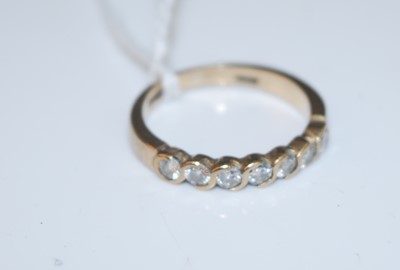 Lot 384 - A modern 9ct gold and diamond half hoop ring,...