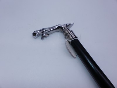 Lot 475 - A reproduction walking cane having ebonised...