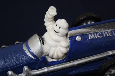 Lot 520 - A reproduction painted cast iron Michelin Man...