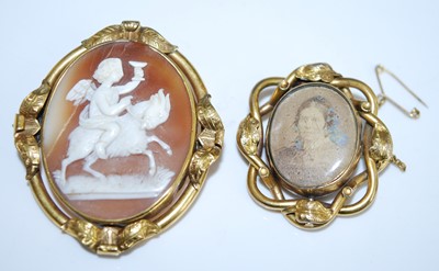 Lot 2547 - Two brooches, being a yellow metal oval carved...