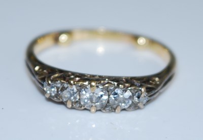Lot 2548 - A yellow metal diamond five stone half hoop...