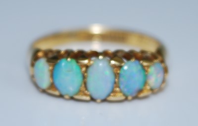 Lot 2555 - An 18ct yellow gold opal five stone half hoop...
