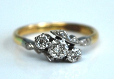 Lot 2557 - A yellow and white metal diamond three stone...