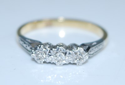 Lot 2558 - A yellow and white metal diamond three stone...