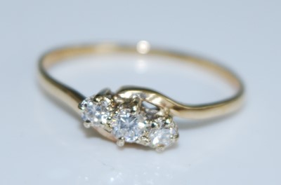 Lot 2561 - A 9ct yellow gold diamond three stone ring,...