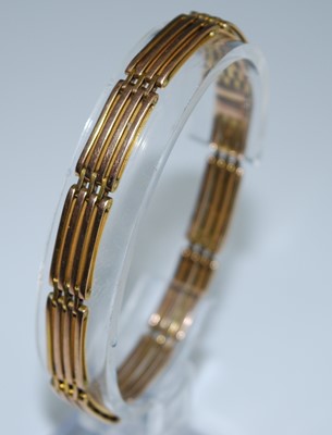 Lot 2592 - A yellow metal four bar gate link bracelet...