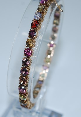 Lot 2595 - A yellow metal tourmaline line bracelet, the...