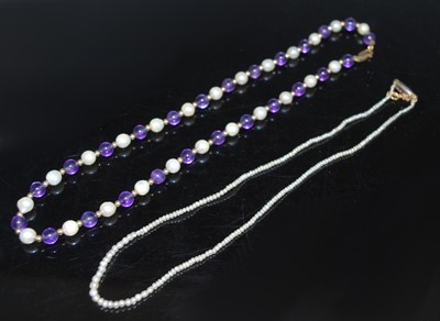 Lot 2597 - Two necklaces.  A yellow metal alternating...