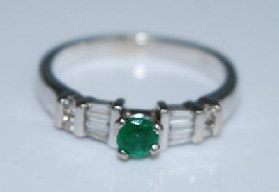 Lot 2602 - An 18ct white gold, emerald and diamond dress...
