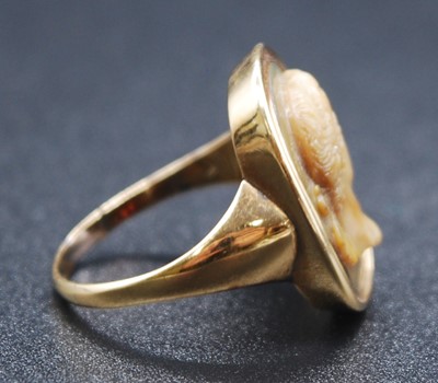 Lot 2615 - A yellow metal carved Lava Stone cameo ring...