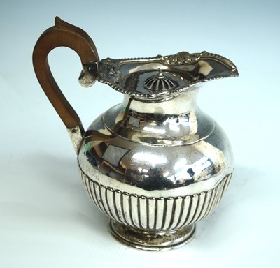Lot 2157 - A late Victorian silver hot water jug, of half-...