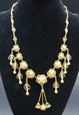 Lot 2642 - A Middle Eastern yellow metal necklet,...
