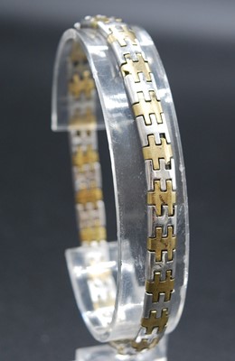 Lot 2645 - A modern 9ct yellow and white gold flatlink...