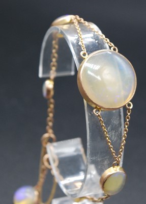 Lot 2659 - A 9ct gold and cabochon opal set bracelet,...