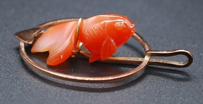 Lot 2687 - A 9ct gold and carnelian pendant, centre set...