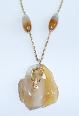 Lot 2744 - A carved agate pendant with yellow metal sea...