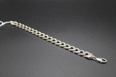 Lot 2793 - A modern silver gents flat curb link bracelet,...