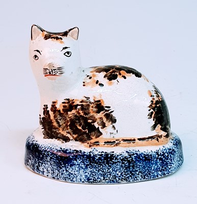 Lot 2078 - A circa 1860 Staffordshire model of a cat,...
