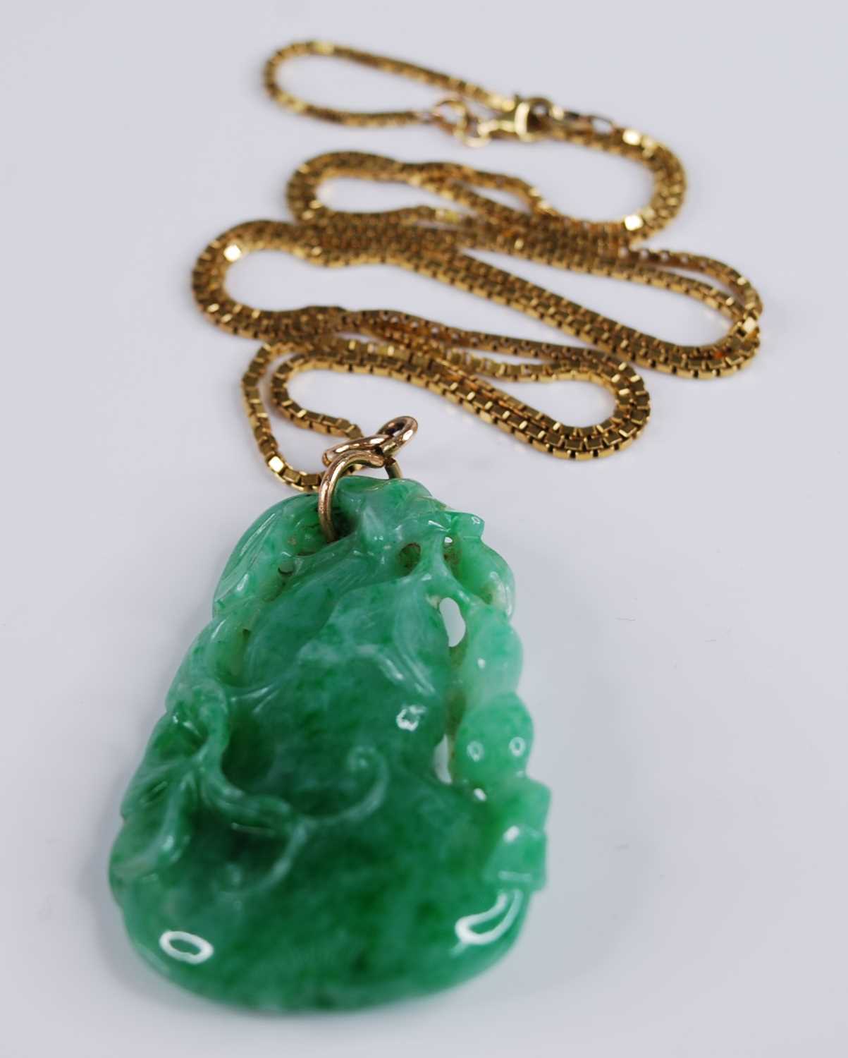 Lot 2218 - A Chinese carved green and celadon jade...