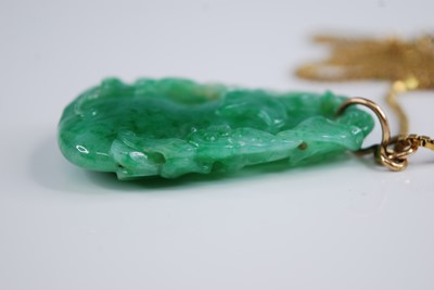 Lot 2218 - A Chinese carved green and celadon jade...