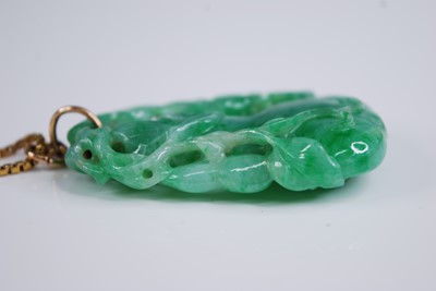 Lot 2218 - A Chinese carved green and celadon jade...
