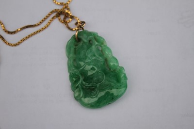 Lot 2218 - A Chinese carved green and celadon jade...