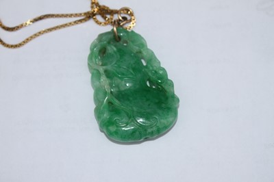 Lot 2218 - A Chinese carved green and celadon jade...