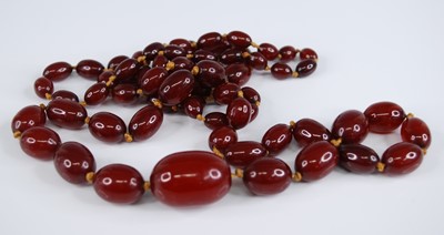 Lot 2260 - A cherry amber necklace, the 66 graduated...