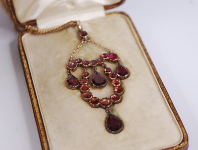 Lot 2194 - An Edwardian yellow metal and garnet set...