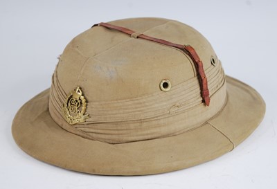 Lot 174 - A WW II Foreign Service cloth covered pith...