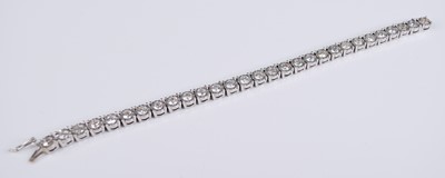 Lot 2199 - An 18ct white gold diamond set tennis bracelet,...