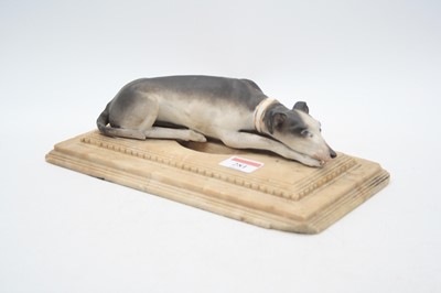 Lot 281 - A bisque porcelain model of a recumbent...