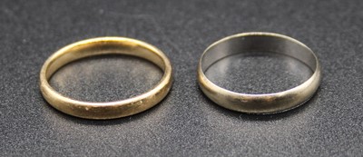 Lot 520 - A 9ct yellow gold wedding band; together with...