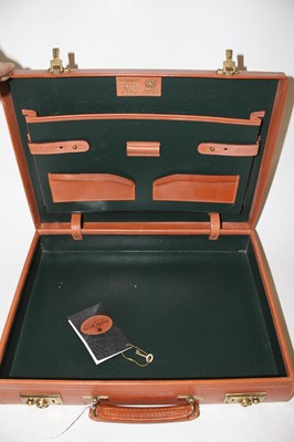 Lot 555 - A leather attache case with brass locks,...