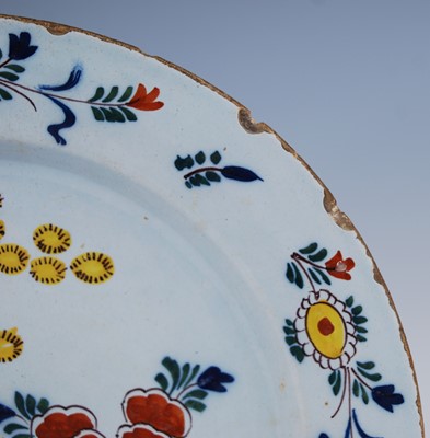 Lot 2103 - An English polychrome Delftware charger,...