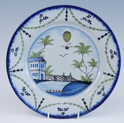 Lot 2056 - A Lambeth polychrome delftware plate, Thomas...
