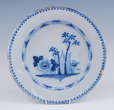 Lot 2074 - An English blue and white delftware charger,...